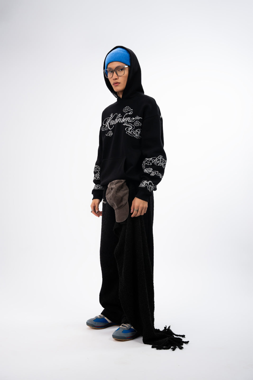 Side profile of Heir of Light oversized black hoodie worn by model