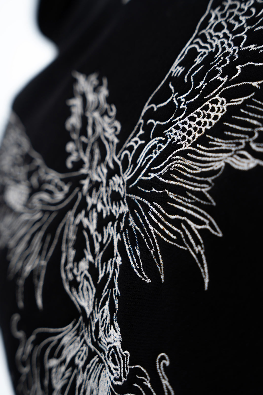 Close-up of a black and Black embroidered hoodie design