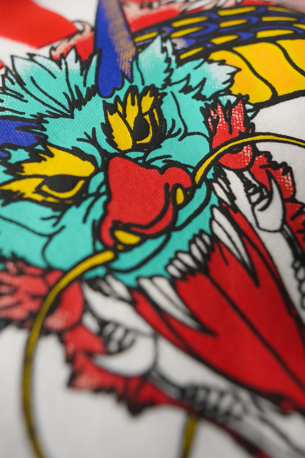 Detailed view of Blinding Fang hoodie artwork print on off white fabric