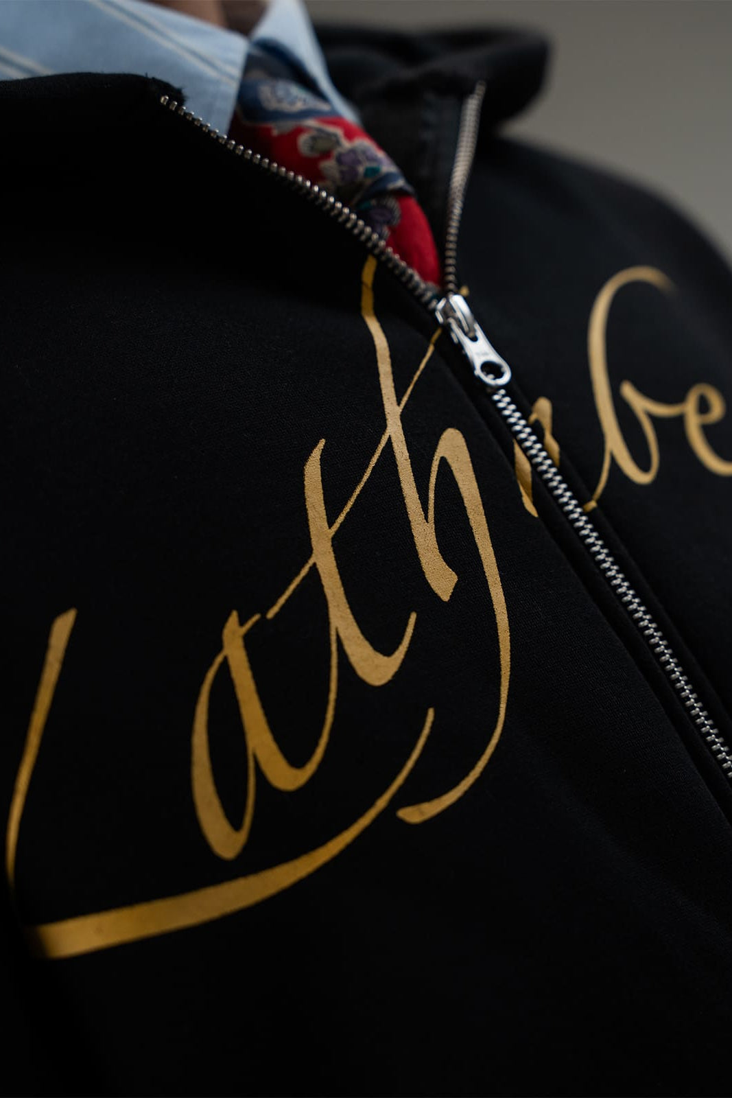 Kathnbenz branding detail on Dominion black fleece jacket